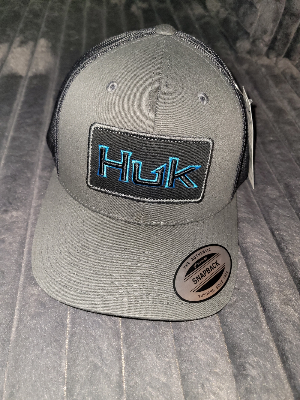 Huk Snapback Hat in Charcoal with Blue Logo